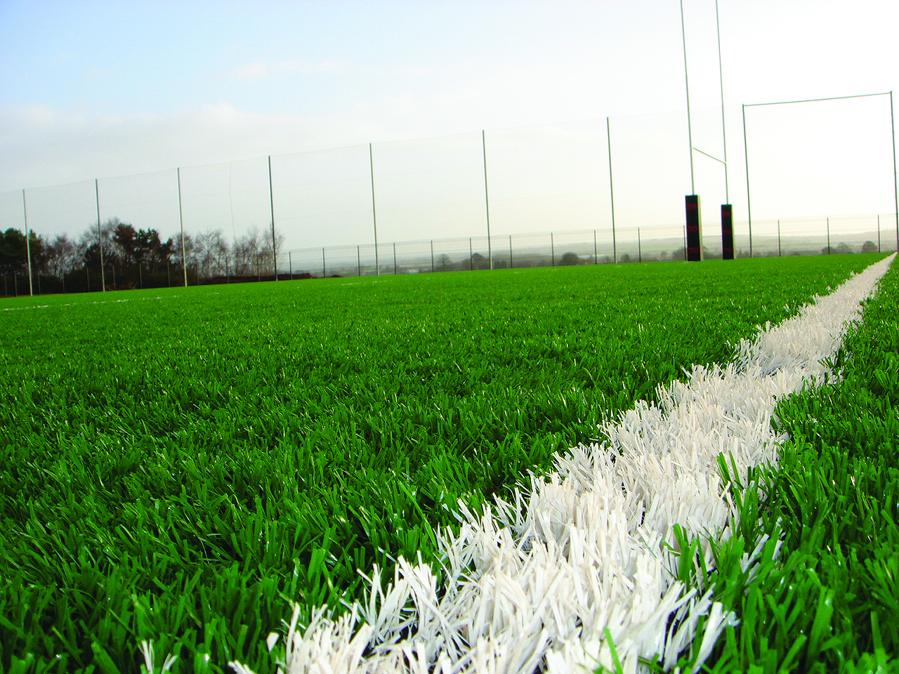 Kids playing at synthetic grass for outdoor flooring